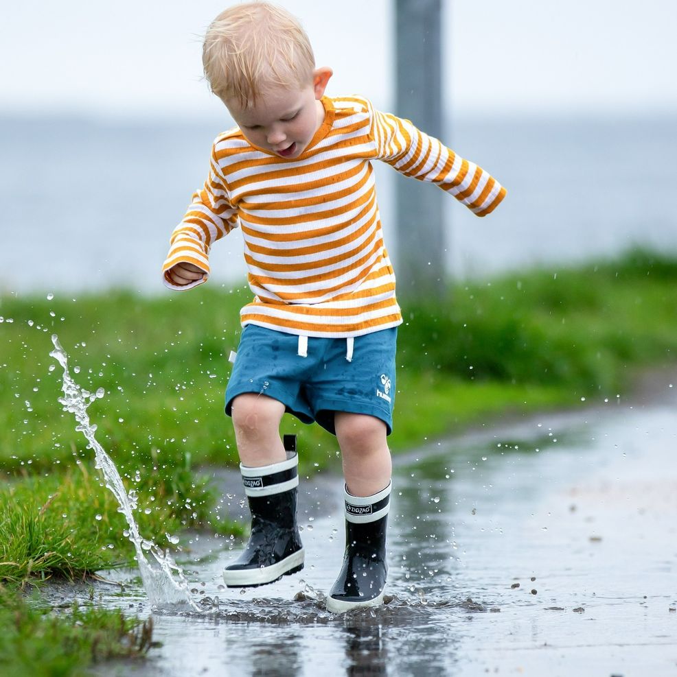 dreng leger i regnen - fotograf Hoppesphoto 